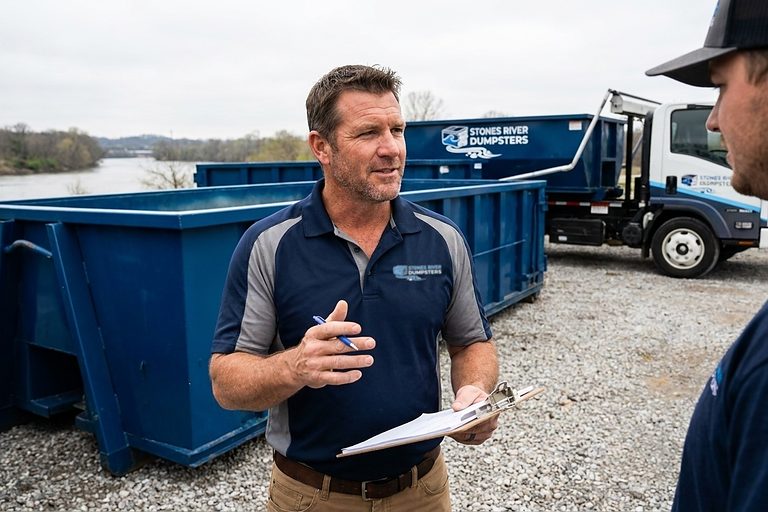 Stones River Dumpsters crew with containers beside the river